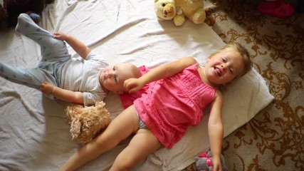 a little girl throws a plush toy
