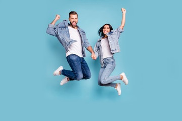 Photo of rejoicing overjoyed nice charming couple wearing jeans denim jackets enjoying their free...