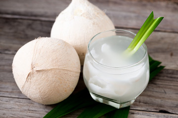 Fresh coconut juice in a glass with coconut white meat isolated on white