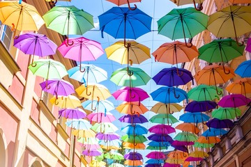 Fototapeta na wymiar Umbrellas in the air . bright small streets of the city