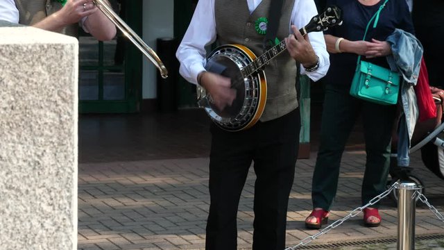 Band playing great music on the street people walking around