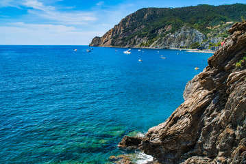 Fototapeta na wymiar Mountainous coast of the Ligurian Sea / Mountain view, sea harbor with boats / Cinque Terre