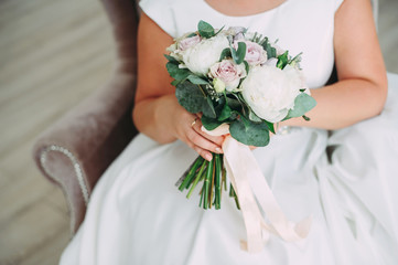 beautiful wedding bouquet in the hands of the bride