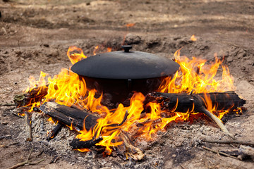 Tourist cauldron on fire. Process of cooking in the forest, outdoor activities.