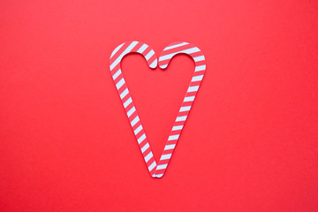 Christmas seamless pattern. Red colors. Candy canes and on red background