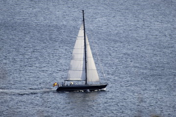 Small sailboat sailing across the Atlantic Ocean