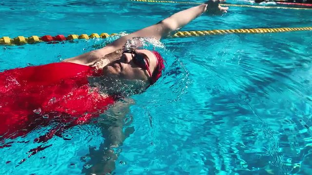 Backstroke Professional Swimming training. woman athlete swim her practice in pool