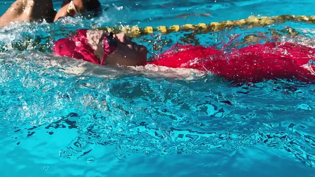 Professional Backstroke Swimmer woman swim Competition Workout in slow motion