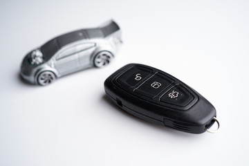 Obraz premium Car loan, Insurance, buy and sell and Auto Finance conceptual image with Car Key remote, die cast car and dollar bills 