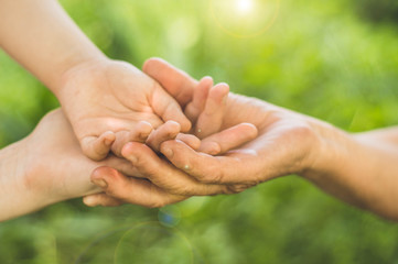 Childs hand and old hand grandmother. Concept idea of love family protecting children and elderly people grandmother friendship togetherness relationship Two generation.