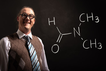 Professor presenting handdrawn chemical formula of dimethylformamide