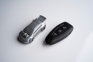 Car loan, Insurance, buy and sell and Auto Finance conceptual image with Car Key remote, die cast car and dollar bills 