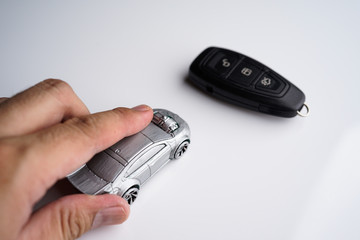 Car loan, Insurance, buy and sell and Auto Finance conceptual image with Car Key remote, die cast car and dollar bills 