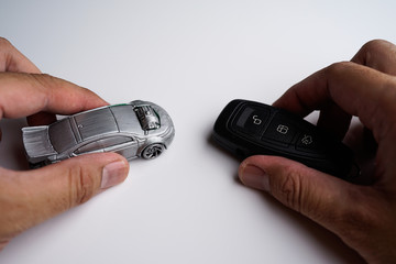 Car loan, Insurance, buy and sell and Auto Finance conceptual image with Car Key remote, die cast car and dollar bills 