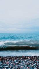 Vertical view from above of sea. Perfect for vertical wallpaper. Meditation on the sea - sea stones