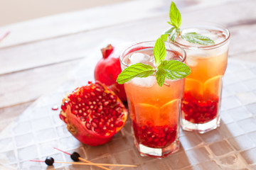 Mojito cocktail with pomegranate, mint, lemon juice and ice