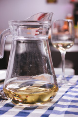 Nearly empty pot ofwater and glass of wine