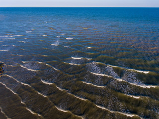 Aerial shot of waves on the sea in Bexhill Sussex