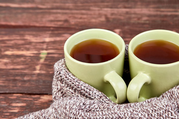 Two warm cups of tea, autumn leaves on wooden table. Autumn. Fall season. Still life. Flat lay. Top view.