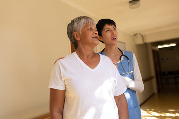 Fototapeta premium Senior female patient and female nurse standing