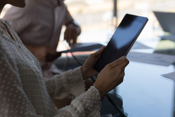 Female executive working on digital tablet in office