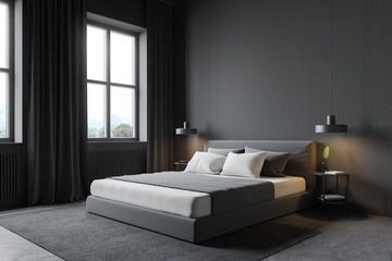 Gray bedroom corner with windows