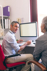 Obraz premium Male doctor and senior woman interacting with each other 