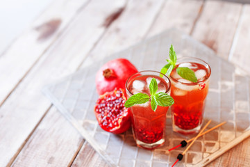 Mojito cocktail with pomegranate, mint, lemon juice and ice
