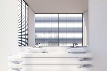 Close up of double sink in white bathroom