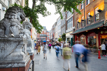 Lisle Street In London Chinatown UK With Motion Blurred Tourists