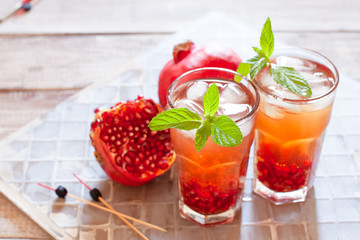 Mojito cocktail with pomegranate, mint, lemon juice and ice