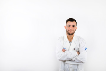 Smiling and willing Young male doctor with beard with arms folded isolated on white background