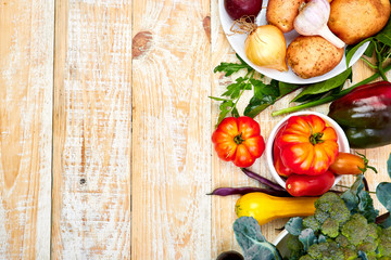 Fresh colorful organic vegetables from above. Top view, flat lay. Different vegetables for eating healthy on wooden background. Clean eating food frame. Copy space. Vegetarian, vegan..