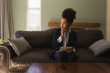 Female real estate agent using digital tablet in living room