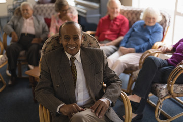 Fototapeta na wymiar Front view of senior man looking at camera in nursing home