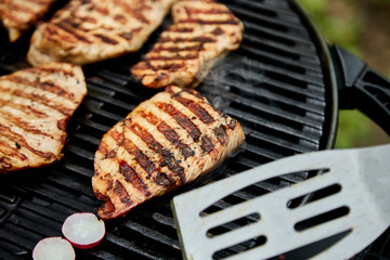 Grilled turkey meat. Steak turkey grill on on huge gas grill . Picnic. Summer. Top view. Flat lay. Copy space.