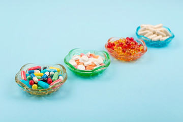 Cold medicine, health care, traditional medicine and flu concept. Various multi-colored pills and capsules, treatment of colds, flu and runny