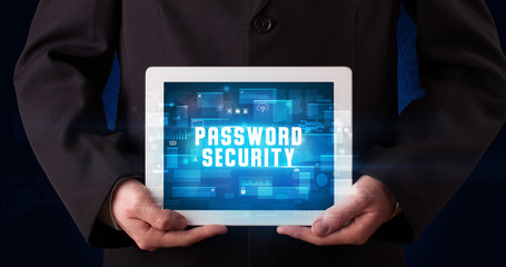 Young business person working on tablet and shows the digital sign: PASSWORD SECURITY