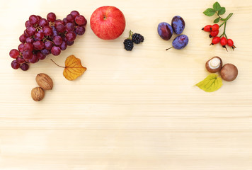 Naklejka na ściany i meble autumn background with fruits, nuts and autumn leaves