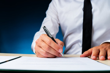 Business manager signing a document