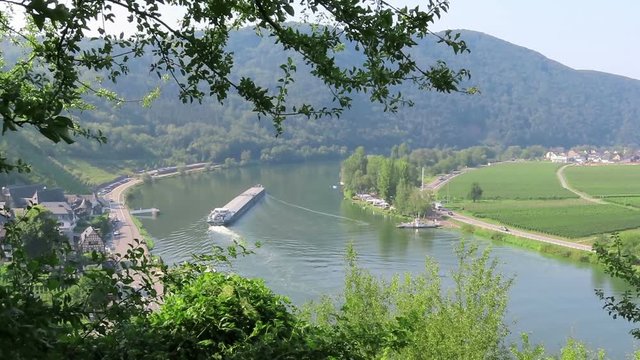 industrial ship barge on Moselle river next to villages Beilstein and Ellenz (Rhineland-Palatinate) in Germany.