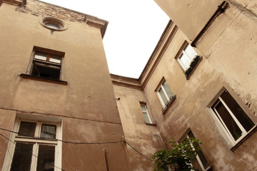 Old town residential building walls with windows bottom-top view