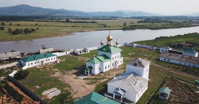 Holy Trinity Selenginsky Monastery flight above helicopter drone. Near Ulan-Ude best Russian nature panorama open space. Forward move cinematic. Sunny day.