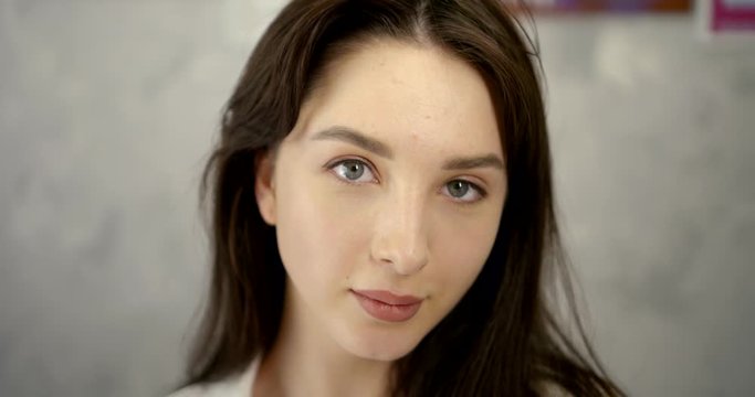 Close-up portrait of a young girl after the procedure of permanent makeup demonstration of the result