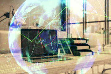 Stock market chart with globe hologram and desktop office computer background. Multi exposure. Concept of financial analysis.
