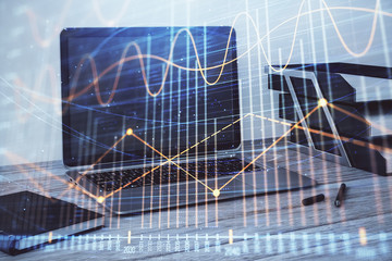 Stock market chart and desktop office computer background. Multi exposure. Concept of financial...