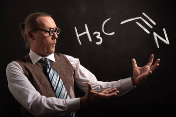 Professor presenting handdrawn chemical formula of acetone