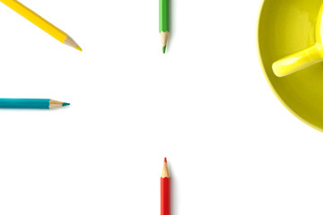 colored pencils and part of a mug on an isolated white background. Copy space.