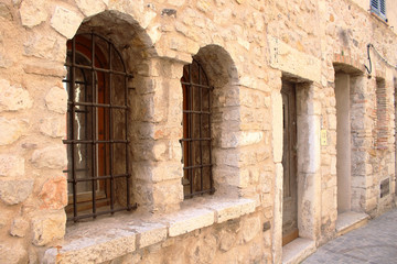Brick wall windows with bars, ancient jail museum architecture view