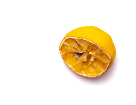 Squeezed out rotten lemon half isolated on white.